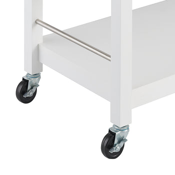 A close-up shot of the lower section of a white kitchen cart with two black wheels visible on the left and right. A silver bar extends horizontally between the two white legs of the cart, just above the lower shelf.