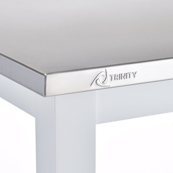 A close-up shot of a stainless steel tabletop with a beveled edge, featuring the 