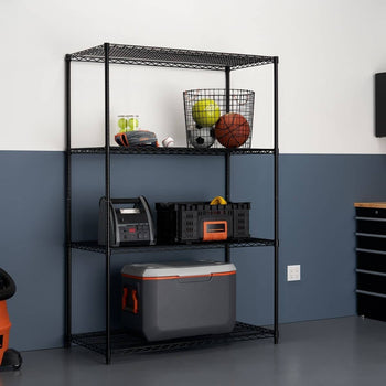 A black, four-tier wire shelving unit stands in a garage or storage area against a white and dark blue wall. The shelves hold various items including sports equipment in a basket, a battery charger, a black storage crate, and a gray and orange cooler.