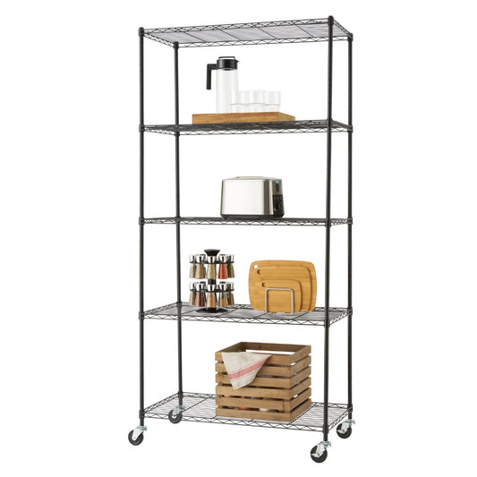 A tall, black Trinity Basics 5-Tier Wire Shelving Rack with wheels is shown against a white background. The shelves hold various kitchen items, including a water pitcher and glasses, a toaster, a spice rack, cutting boards, and a wooden crate with a cloth.
