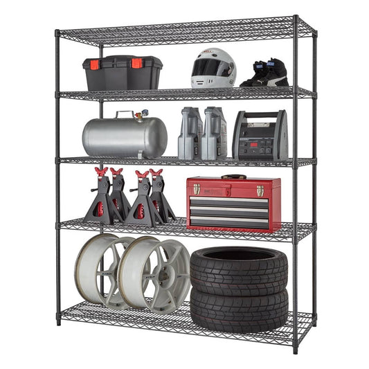 A wide five-tier black anthracite wire shelving rack filled with garage items like tool boxes, racing helmet and boots, gas tank, jack stands, and a pair of tires and rims.
