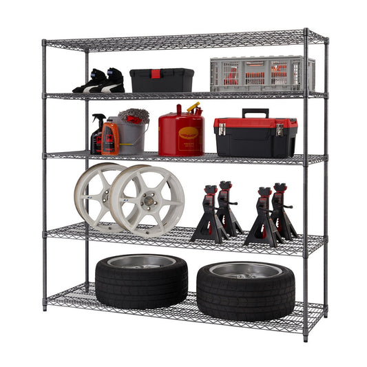 A five-tier black wire shelving unit stands against a white background, holding various automotive and household items. From bottom to top, the shelves contain two stacked tires, two white car wheels and four black jack stands, a red gas can and a black and red toolbox, a grey bucket with cleaning supplies, and a black toolbox and a grey and red storage crate.