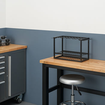 A workbench with a butcher-block top stands in a workshop, featuring a metal tool organizer and a silver stool. On the left, a rolling metal cabinet with several clear plastic storage boxes rests on a matching countertop.