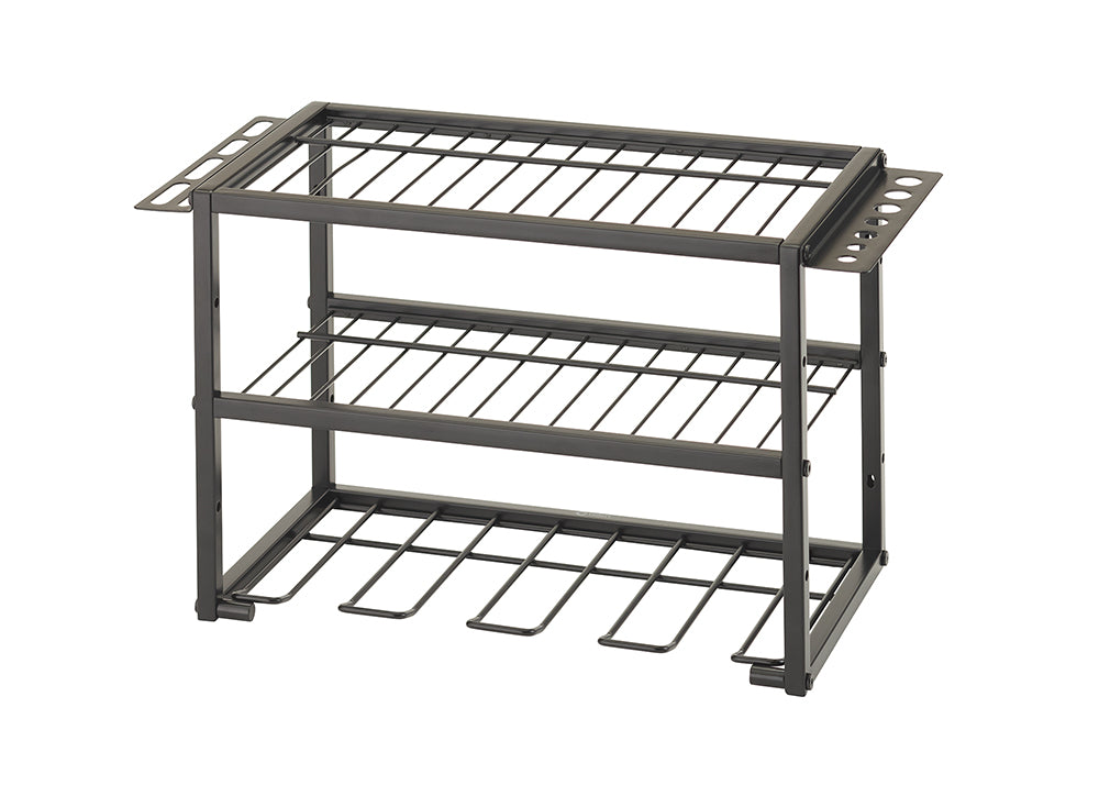 A three-tier, dark gray metal rack for organizing power tools and accessories. The top two tiers are wire shelves, and the bottom tier has several U-shaped holders for hanging cordless drills.