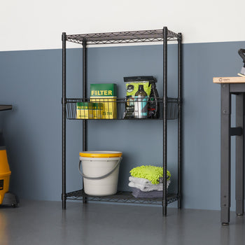A black wire shelving unit with three tiers stands against a two-toned wall, holding various cleaning supplies. To the left, a yellow wet/dry vacuum is visible, and to the right, a metal work table with a stool is partially seen.