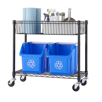 A two tier black metal wire shelving unit on wheels that is the bottom part of a split original five tier shelf that holds two blue recycling bins on the bottom shelf and two white plastic bins on the top shelf. The top shelf also contains a roll of paper towels, a spray bottle, and a dustpan.