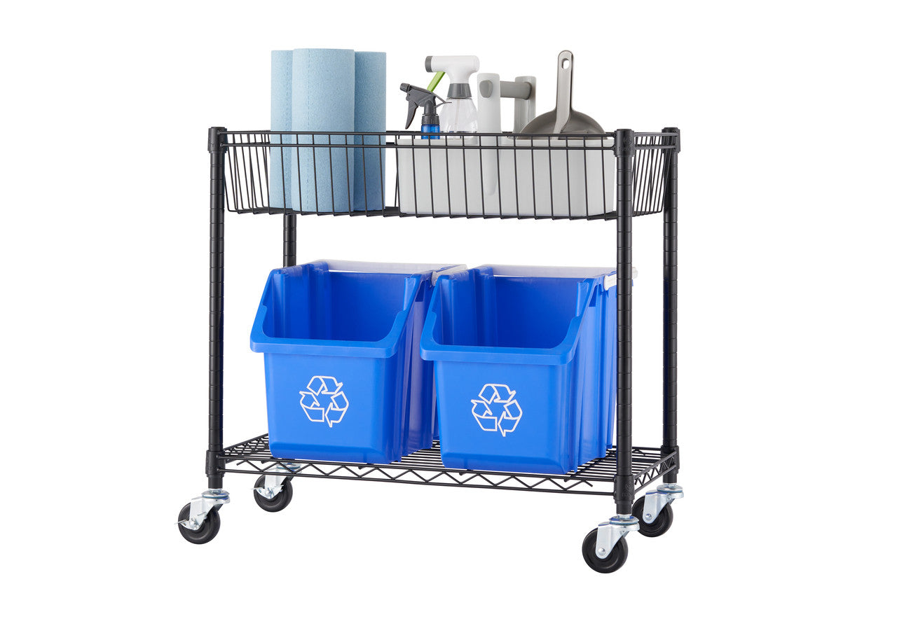 A two tier black metal wire shelving unit on wheels that is the bottom part of a split original five tier shelf that holds two blue recycling bins on the bottom shelf and two white plastic bins on the top shelf. The top shelf also contains a roll of paper towels, a spray bottle, and a dustpan.