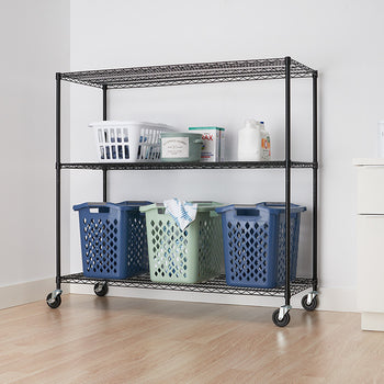 A black wire shelving unit with three tiers and wheels is positioned against a white wall. The shelves hold various laundry items, including baskets and detergent.