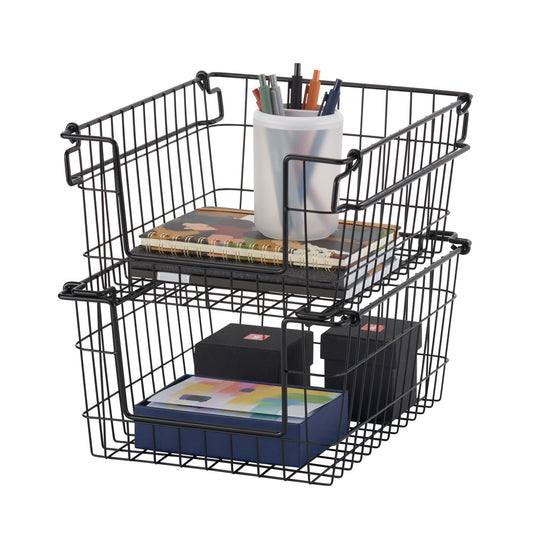 Two black wire baskets stacked on top of each other, filled with various items like notebooks, pens, and boxes, against a white background. The baskets are identical, with a simple wire frame design and handles on the sides.