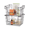 A set of two black wire stacking baskets filled with pantry items, including almond flour, baking soda, a bottle of oil, and a container of sugar. The baskets have handles that allow them to be stacked or used separately for storage organization.
