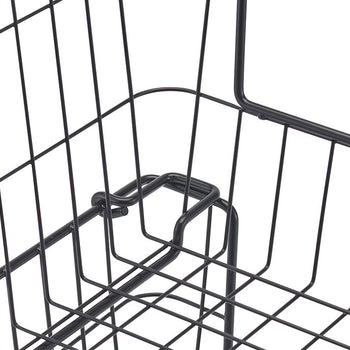 A close-up shot shows a black metal wire basket with a handle, highlighting the detail of the wire construction and the handle's attachment point. The basket's grid pattern and the curved design of the handle are clearly visible.