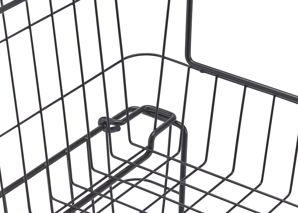 A close-up shot shows a black metal wire basket with a handle, highlighting the detail of the wire construction and the handle's attachment point. The basket's grid pattern and the curved design of the handle are clearly visible.