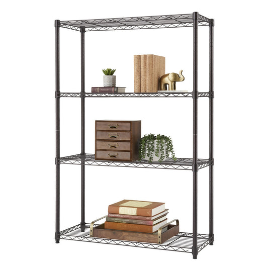 A four-tier bronze wire shelving unit, is shown against a white background. The shelves are sparsely decorated with books, small plants, and decorative objects like an elephant figurine and a small set of wooden drawers.