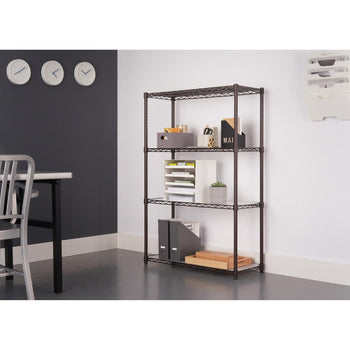 A four-tier bronze wire shelving unit stands against a white wall in an office setting. The shelves hold various office supplies, and three round white clocks hang on the dark gray wall to the left.