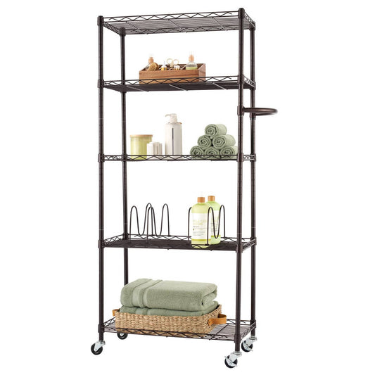 A tall, five-tier pantry rack made of dark bronze metal stands upright. The rack has wheels at the bottom and contains various items, including towels, bottles, and a wooden tray.