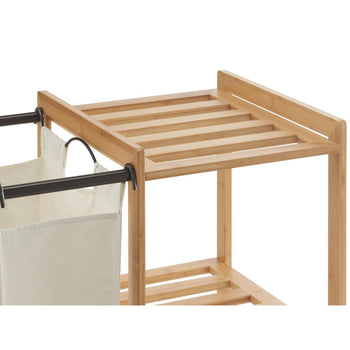 A close up of the slated bamboo shelf of the laundry station. A light-colored fabric laundry bag hangs from a bronze metal rod on the left, next to the natural bamboo frame with slatted shelves.