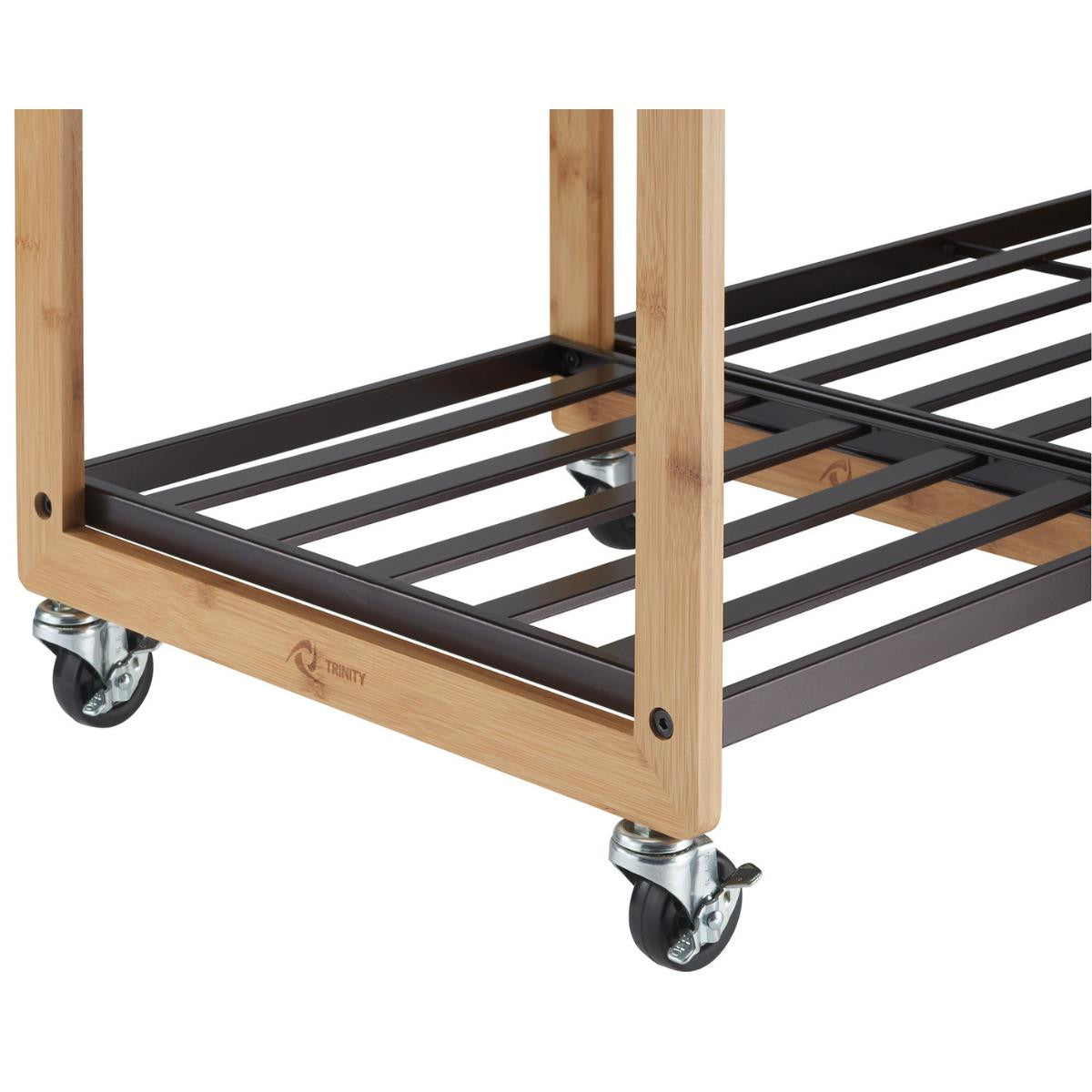 A close-up shot of the base of a Trinity 3-Bag Laundry Station with Wheels, featuring a natural bamboo frame with the trinity logo found at the bottom center of the bamboo frame and bronze metal shelves. Three black caster wheels are visible, two of which have locking mechanisms.