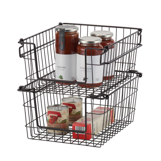 A close-up studio shot of two dark bronze wire baskets stacked on top of each other, containing jars and cans of food. The baskets are empty and isolated on a white background.