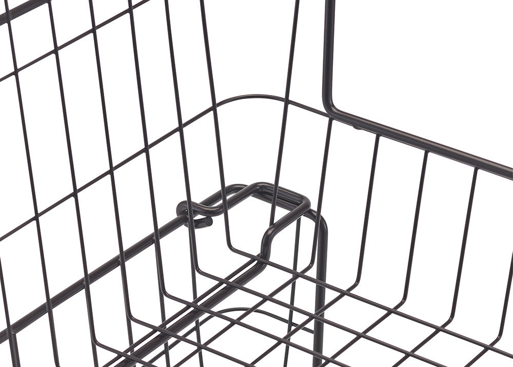 A close-up shot of the corner of a dark metal wire basket, highlighting the curved handle and the grid pattern of the wire. The handle's design shows a loop where it connects to the basket's side.