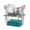A black wire storage basket with two tiers holds various pet care items. The top tier contains a bottle of probiotic shampoo, a jar of dog treats, a blue tennis ball, and a green leash, while the bottom tier holds a folded teal pet blanket with a bone and paw print pattern.