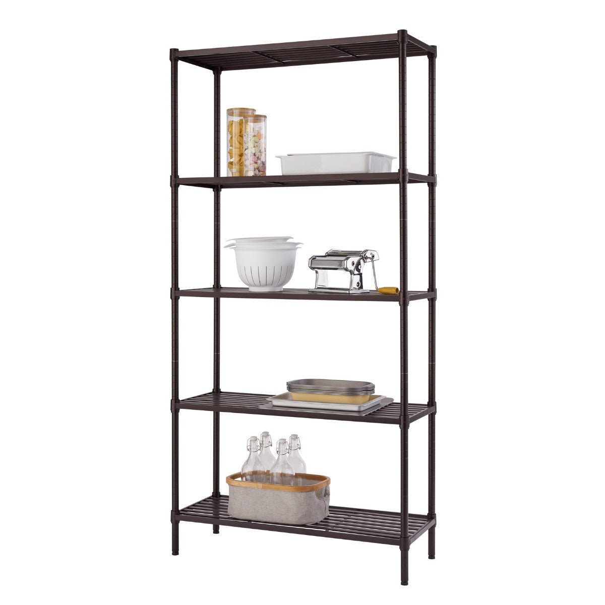 A tall, dark bronze, five-tier wire shelving unit. The shelves are sparsely organized with various kitchen and pantry items, including glass jars, a white baking dish, a colander, a pasta maker, and a basket holding glass bottles.