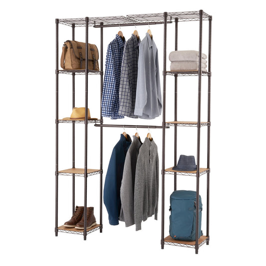 An adjustable, dark brown metal wire closet organizer with light brown wooden shelves is filled with clothes and accessories. On the left, a brown bag, two shirts on hangers, a hat, and a pair of boots are displayed, while the right side holds folded towels, a hat, and a blue backpack, with three long-sleeved shirts hanging in the middle.