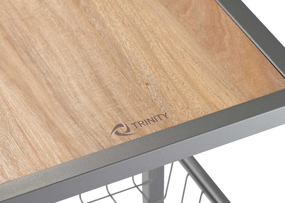 A close-up shot shows a light brown wooden surface with the word "TRINITY" and a swirl logo etched into it. The wood is framed by a gray metal border.