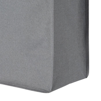 A close-up shot of a gray fabric-covered corner, likely part of a piece of furniture, showing the texture of the material and the seams. The fabric appears smooth and the corner is sharply defined.