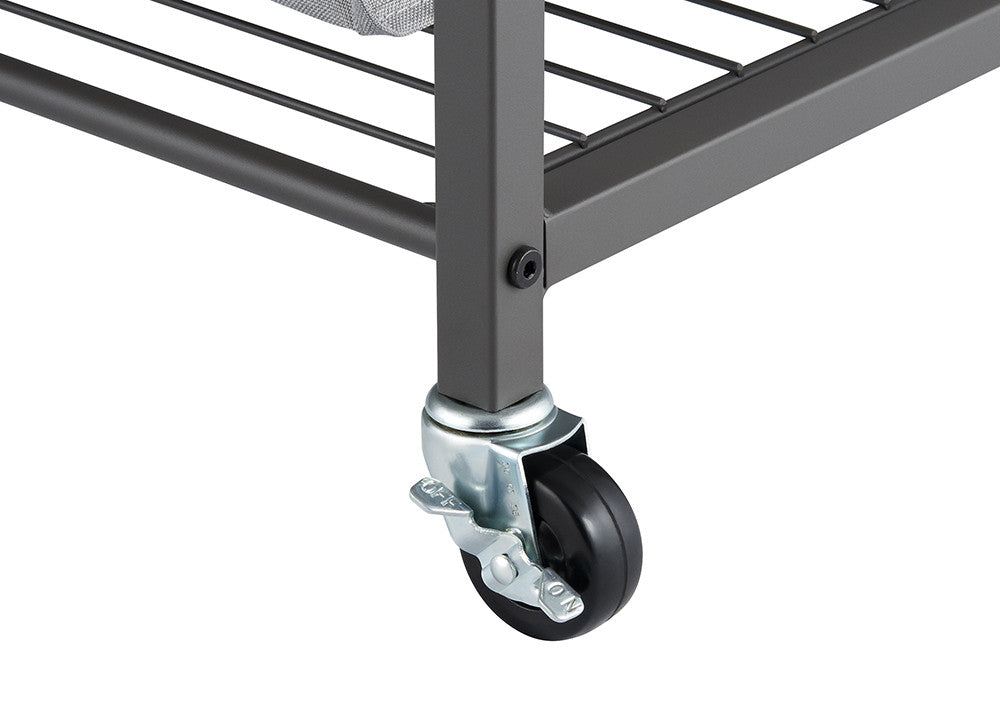 A close-up shot of a gray metal cart leg with a black caster wheel attached. The wheel has a silver metal swivel and a small lever for locking the wheel in place.