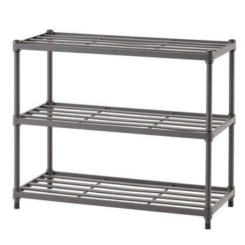 A three-tiered gray metal slat shoe rack stands against a white background. The rack has horizontal slats on each level to hold shoes and vertical supports at the corners.
