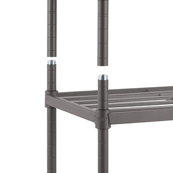 A close-up shot of a gray metal slat shoe rack, focusing on the interlocking posts and shelves. The rack is partially assembled, showing the connection points between the posts and the horizontal supports for the shelves.