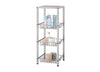 A champagne colored, four-tier metal shelving unit with three slatted baskets is shown against a white background. The shelves hold various bathroom items, including lotions, a toothbrush, towels, and decorative candles.