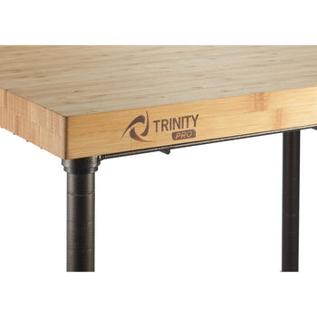 A close-up shows the corner of a Trinity Pro expandable kitchen cart. The cart features a light-colored bamboo top and bronze metal legs.