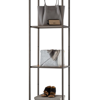 This tall, narrow four-tier shelving unit features a textured dark bronze metal frame with wood-grain accent panels on the top and bottom shelves. It is organized with everyday essentials, including a grey leather handbag and wallet on the second tier, a grey fabric storage bin on the third, and a pair of black sandals atop a woven storage box on the bottom shelf.