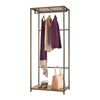 A bronze-colored metal garment rack stands against a white background, showcasing three hanging garments: a long purple dress, a light brown sweater, and a purple cardigan. Below, on a wooden shelf, are a pair of brown heeled sandals and a beige and brown tote bag.
