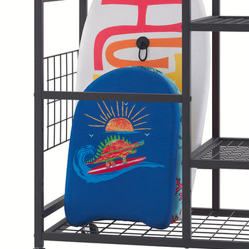 A close-up view of the base of a black rolling storage cart shows two bodyboards neatly organized on its bottom wire mesh shelf, against a clean white background. In front, a smaller blue bodyboard features a vibrant graphic of a dinosaur surfing at sunset, while a larger white board sits behind it, showcasing large colorful letters and a black handle.