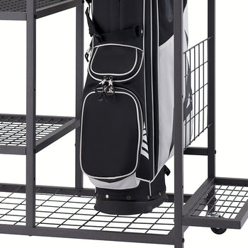 A black and white golf bag rests on the bottom wire mesh shelf of a black metal rolling rack. The rack includes additional multi-level grid shelves and partitions and is shown against a plain white background.