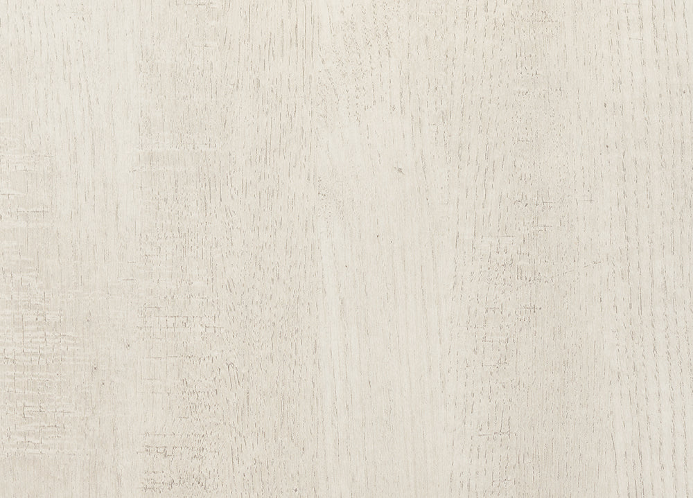 A full-frame, overhead shot shows a light beige, off-white wood surface with a distressed finish. 