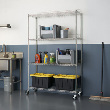 A four-tier wire chrome shelving unit, likely the Trinity EcoStorage 4-Tier Wire Shelving Rack, in a garage or utility room setting. The shelves hold various storage containers and cleaning supplies, illustrating its organizational capabilities.
