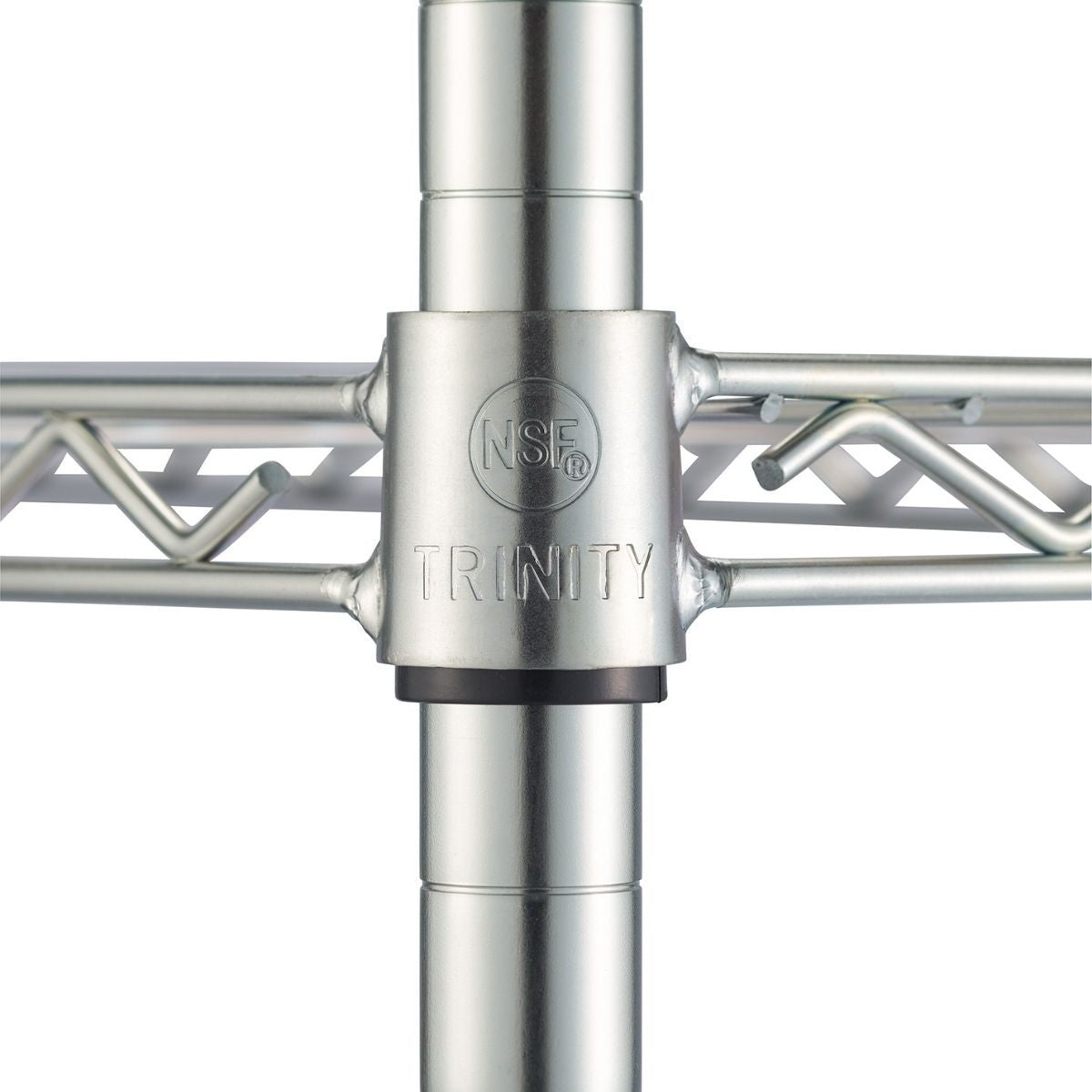 Close-up view of a chrome metal shelving unit's support structure. A black collar sits below a connector piece marked with "NSF" inside a circle and the word "TRINITY" below it, where a shelf's wire frame is attached to a vertical pole.