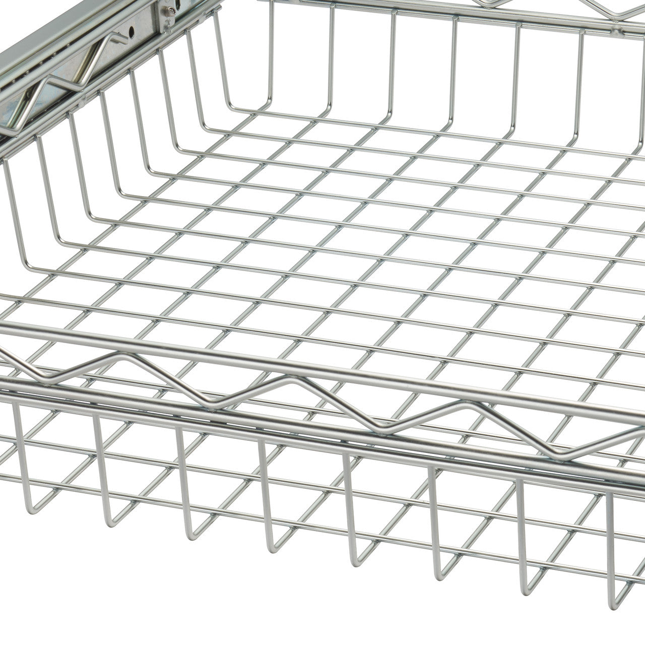 A close-up shows a section of a shiny, silver wire mesh basket or tray. The grid pattern of the mesh is clearly visible, with thicker wires forming the perimeter and supporting structure.