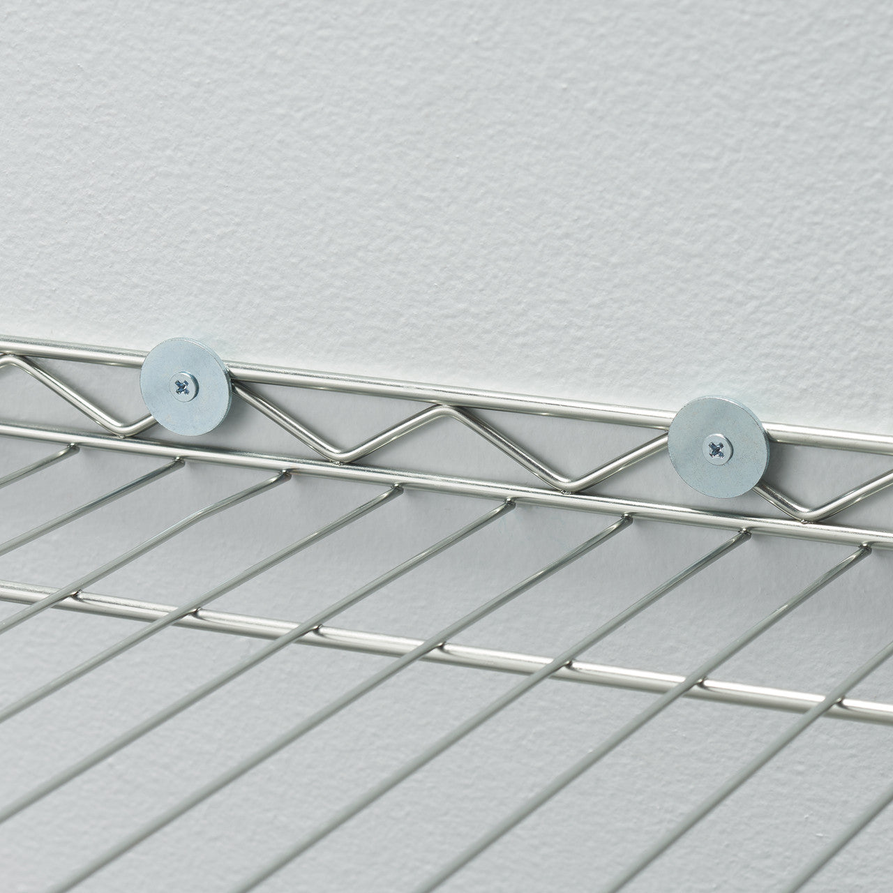 A close-up of a Trinity EcoStorage® 5-Tier Commercial Square Rack with Wheels, NSF, Chrome. The rack has a chrome finish and wire shelves.