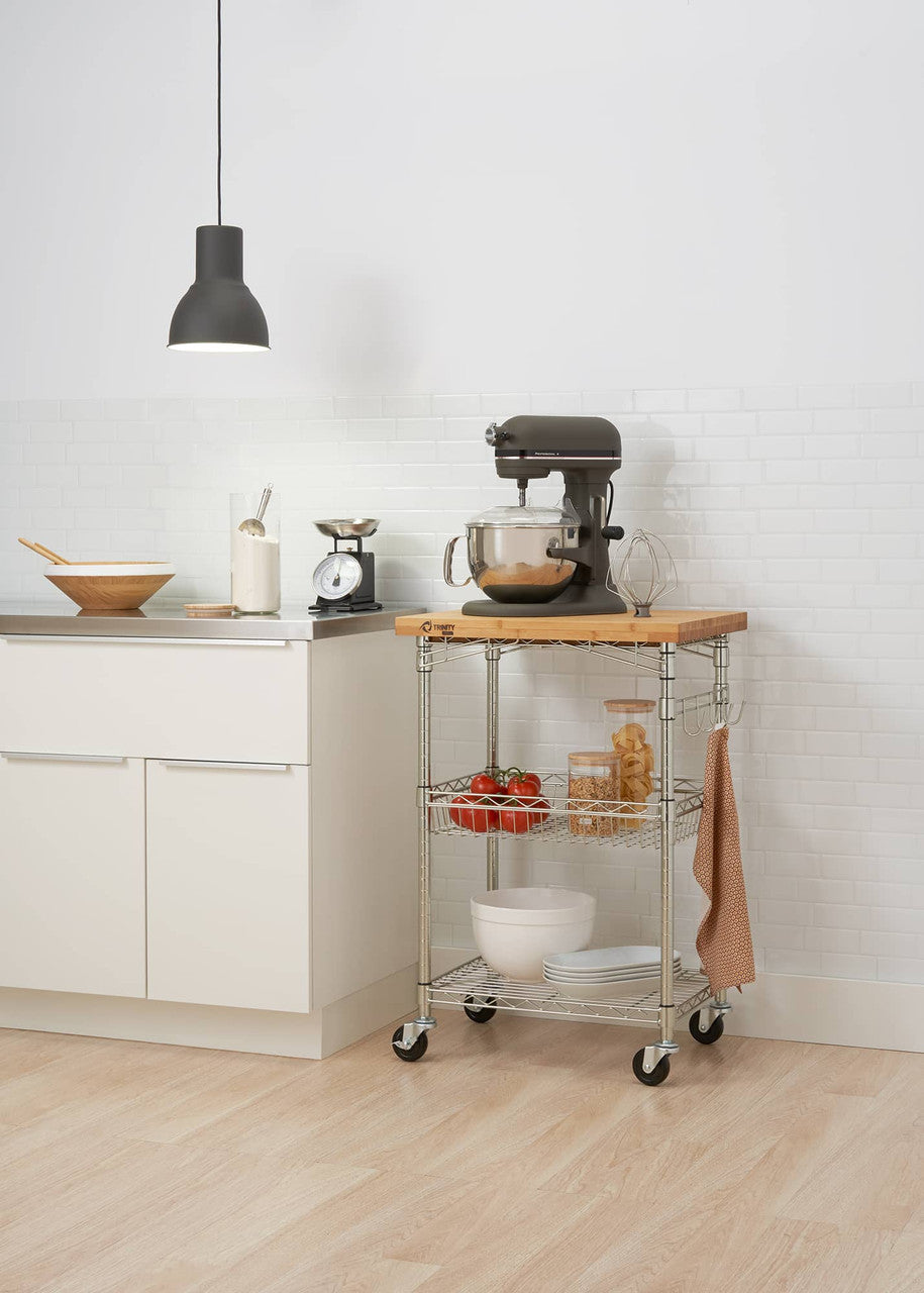 A Trinity Pro® EcoStorage® Expandable Bamboo Top Kitchen Cart. The cart is equipped with shelves and is placed in a kitchen setting.