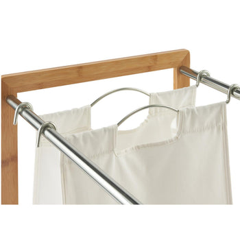 A close up of the laundry bags of a bamboo laundry cart attached by a chrome metal hook to a removable chrome metal rod. 
