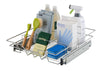 A stainless steel wire sliding drawer is shown extended, filled with various cleaning supplies. The drawer contains bottles, boxes of gloves, brushes, and sponges, suggesting it's used for under-sink or pantry organization.