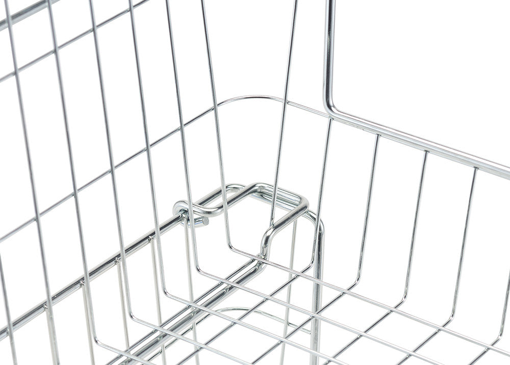 A close-up shot shows the corner of a chrome wire basket, highlighting the construction with thin, parallel wires and a small hook-like detail. The focus is on the intricate wire pattern and the basket's shiny, reflective surface.