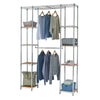 A chrome wire closet organizer with wooden shelves is shown against a white background. It features multiple shelves holding folded blankets, baskets, and storage bins, along with two hanging rods displaying various shirts and sweaters.