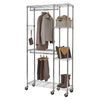 A chrome wire shelving unit on wheels serves as a closet organizer. It features hanging rods for clothes, multiple shelves holding bags, shoes, and a storage box, and hooks for accessories.