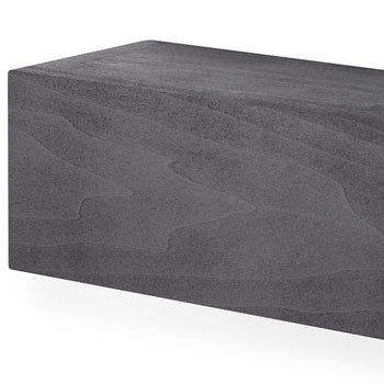 A close-up shot shows the corner of a rectangular, featuring a textured, stone-like surface. The material displays organic, wavy patterns and subtle color variations that mimic the appearance of layered sedimentary rock or cast concrete.