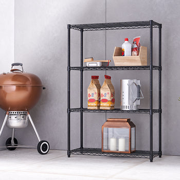 A shiny copper kettle grill with a metal base and two wheels sits next to a black, four-tier wire shelving unit. The shelves hold various items, including a wooden crate with bottles, two bags of charcoal, a chimney starter, and a copper and glass lantern with candles.